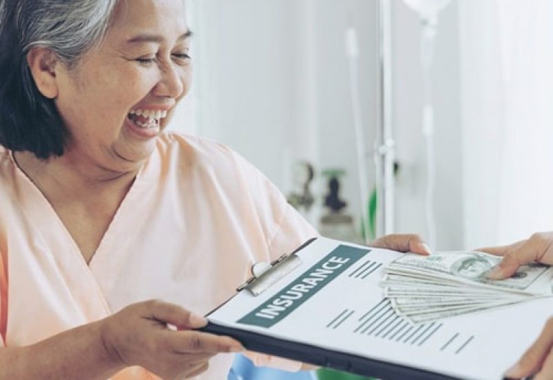 elderly patients injury  woman on Patient's bed in hospital  holding us dollar bills feel happy from getting insurance money From insurance companies